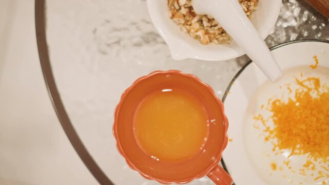 Pumpkin dish presentation. Elegant overhead view of pumpkin puree accompanied by zest and chopped nuts. Modern kitchen display showcasing pumpkin puree in bowl with zest and crunchy nuts