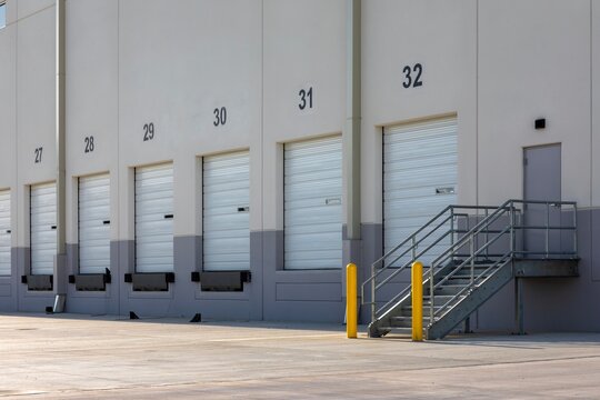 Exterior View of Modern Warehouse Loading Dock Doors with steel staircase