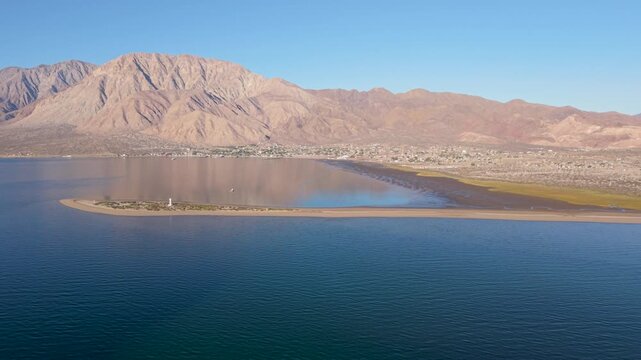 Aerial views capture the sunrise over Bahia De Los Angeles in Baja California Mexico with clear skies and untouched land and water.
