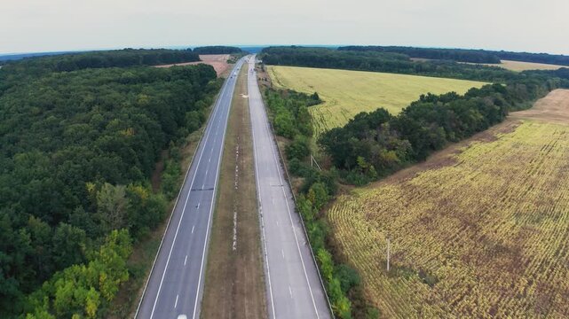 Long two-lane concrete road with traffic in rural area