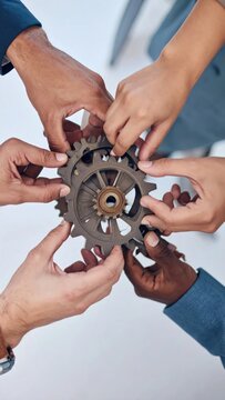 Diverse hands joining gears symbolizing teamwork and collaboration for a shared goal