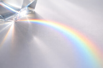 Naklejka premium Prism creating a colorful rainbow on white surface