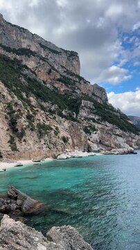 Cala Mariolu beach with white pebbles and turquoise water in the Gulf of Orosei, Sardinia, Italy