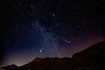 Stars gazing at night on Tenerife, mount Teide vulcano national park night excursion, astronomy educational tour, tourists destination, scenic view on mountains and stars on dark sky © barmalini
