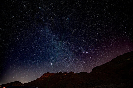 Stars gazing at night on Tenerife, mount Teide vulcano national park night excursion, astronomy educational tour, tourists destination, scenic view on mountains and stars on dark sky
