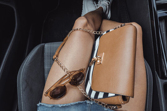 Summer fashion accessories on woman's legs inside car. Ideal for fashion, mobility, independence and warm-weather leisure