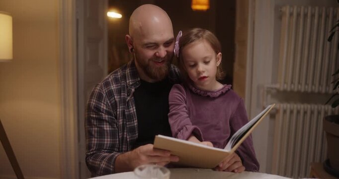 A father and daughter share a magical, laughter-filled moment reading together in their cozy living room