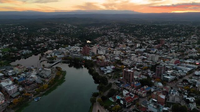 Aerial view of villa carlos paz at sunset with the san roque lake
