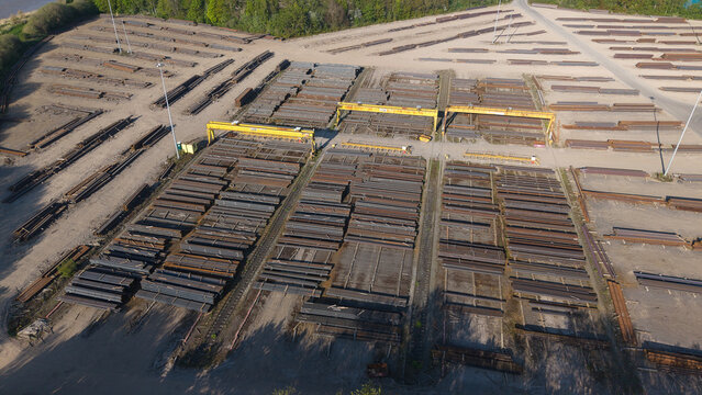 Aerial view of PD Ports showing stacks of steel beams and yellow gantry cranes in an industrial storage yard Scunthorpe, England, United Kingdom.