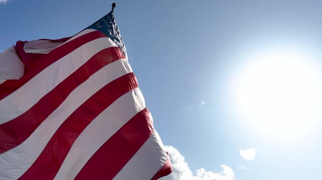 United States Flag Blowing Dramatically in the Wind on a Bright Cloudy Day