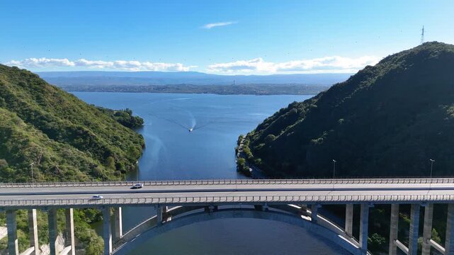 Aerial view of jose manuel de la sota bridge over san roque lake in cordoba