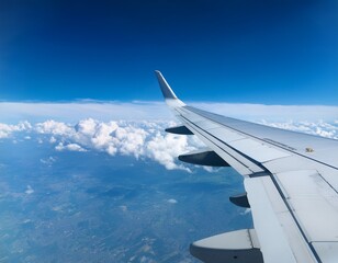 Obraz premium aerial view of blue sky and white clouds top view from airplane window