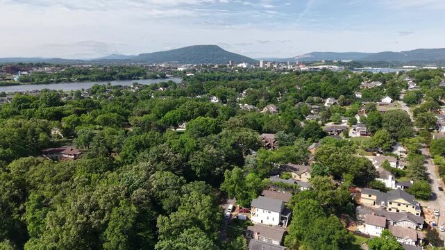 Aerial drone footage of the Riverview neighborhood in North Chattanooga, Tennessee, USA. Tree-lined residential streets, hillside homes, and scenic views near the Tennessee River. 