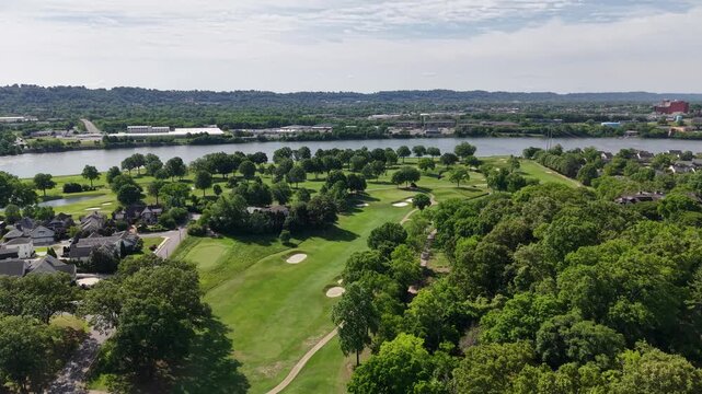 Aerial drone footage of the Riverview neighborhood in North Chattanooga, Tennessee, USA. Tree-lined residential streets, hillside homes, and scenic views near the Tennessee River. 