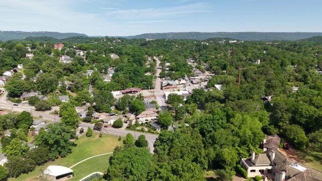 Aerial drone footage of the hillside homes in North Chattanooga, Tennessee, USA. Tree-lined residential streets, hillside homes, and scenic views near the Tennessee River. 