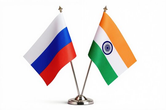 Russia and India national flags stand together on a clean white background. Table flags represent two countries official emblems and symbolize their partnership and diplomatic relations.