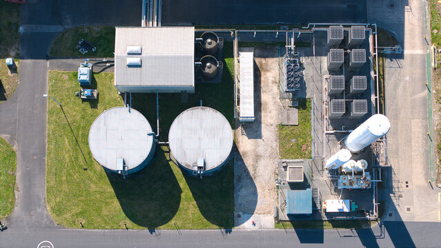 Aerial view of the Industrial Glass Manufacturing Facility with large storage tanks and cooling systems in Goole, England, United Kingdom.
