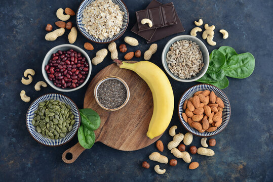 Top view of magnesium rich foods arranged on a dark background