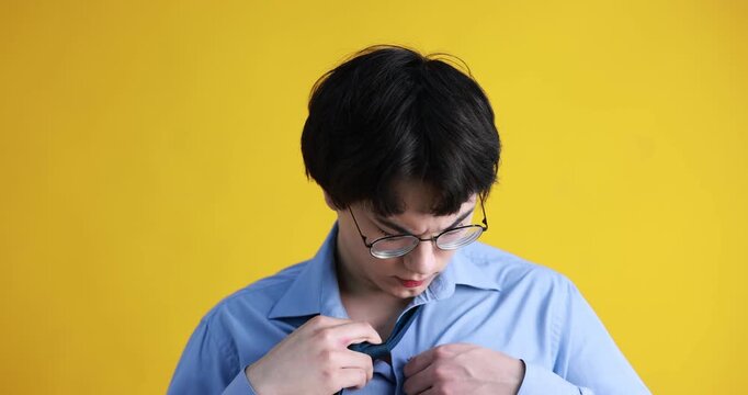 Young guy suffering from sweating on orange background