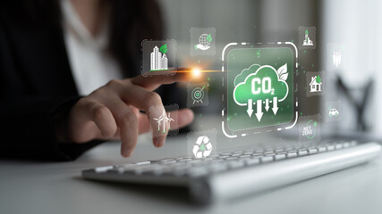 Naklejka premium Business Person Engaging with Digital Carbon Reduction Icons and Eco-Friendly Symbols on Keyboard for Sustainable Development and Environmental Awareness Sigmoid