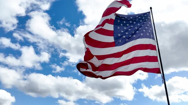 American Flag Blowing in Gentle Wind with Copy Space in Sky