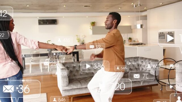 Holding hands man leading woman spinning past sofa to doors for fun, social media overlays floating