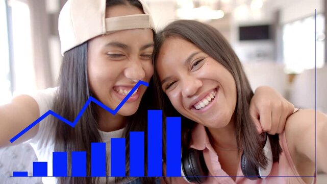 Two women leaning in taking selfie, capturing joy while data chart overlay growing then shrinking