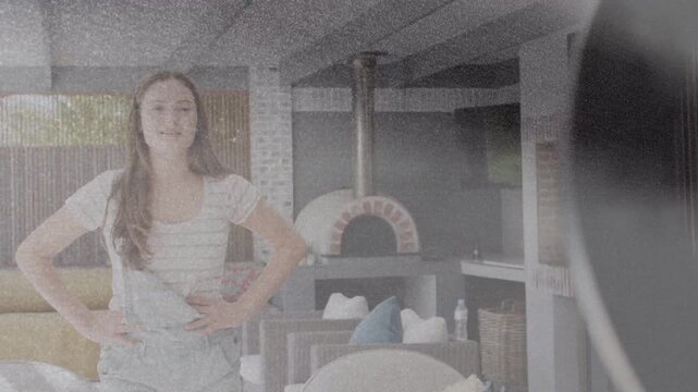 Two teens entering patio, starting phone recording, syncing gestures with ring light for content