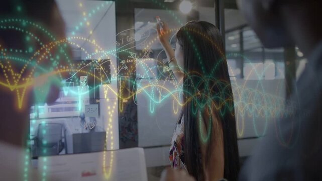 Presenter at glass annotating in business meeting, overlays and glowing bars explaining data