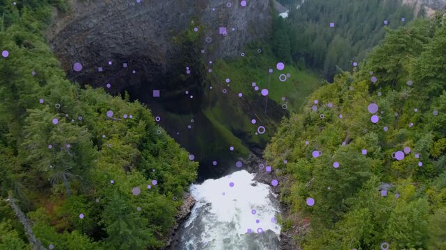 Drone starting descent moving down over falls showing pool mist rising rainbow purple dots floating