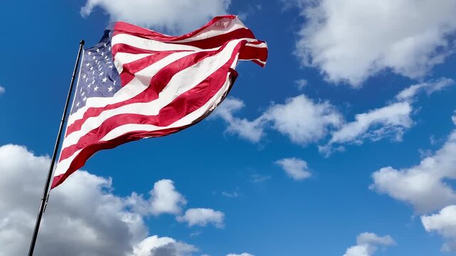 American Flag Blowing in Gentle Wind with Copy Space in Sky
