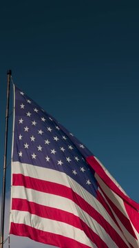 Vertical Seamless Loop of American Flag Waving with Copy Space