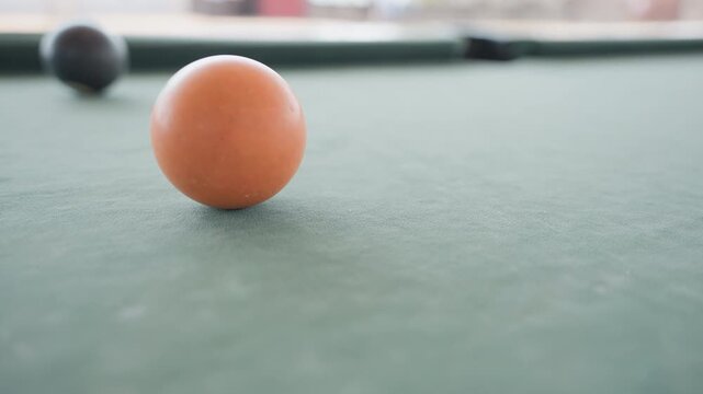 Bright studio lights illuminate waiting cue and cluster of balls. Intense photographic scene showcases poised cue ready to strike amid clustered billiard balls under bright studio illumination