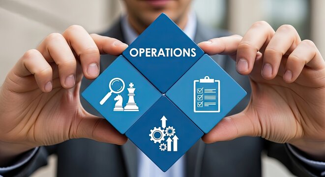 A person wearing a suit holds a diamond shaped blue block with icons of a chess piece and gears while standing in a bright office space with soft lighting.