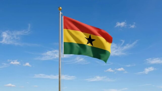 The Ghana flag flies against a bright blue sky.