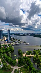 Fototapeta premium Aerial view of a city with a river and green park