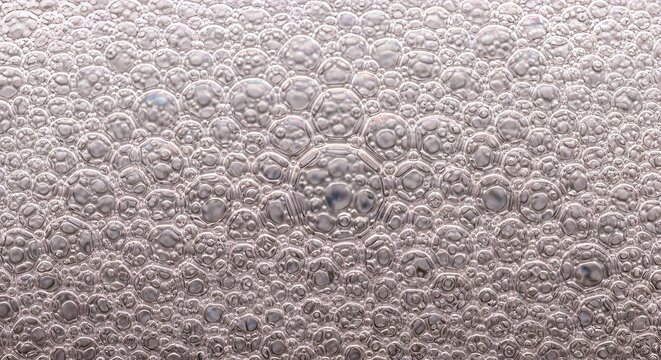 Macro foam bubble texture with soft organic circular patterns and clean abstract surface details. Minimal liquid background captured with smooth lighting in ultra sharp 8K UHD quality.