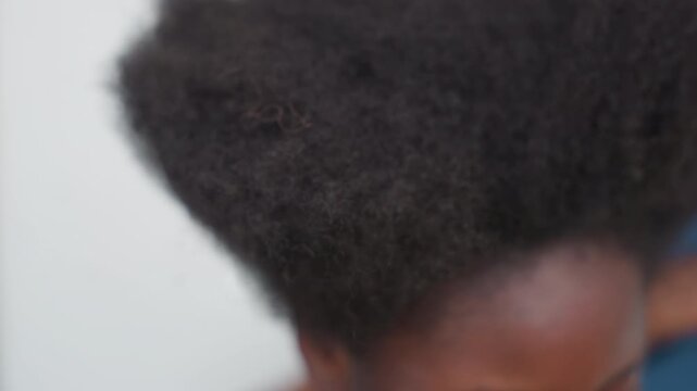 Close up black childs afro texture, fingers inspecting crown and roots, dense coils and soft sheen, studio calm mood, heritage and identity focus, portrait detail emphasizing natural coil pattern