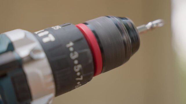 Closeup drill chuck with bit, carpenter drilling pilot hole into timber, soft studio light, shallow depth of field, numeric torque settings visible, steady hand movement, precise carpentry action