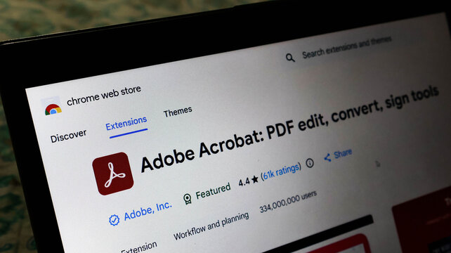 Laptop screen displaying the adobe acrobat extension page on the chrome web store for pdf editing, converting, and signing tools