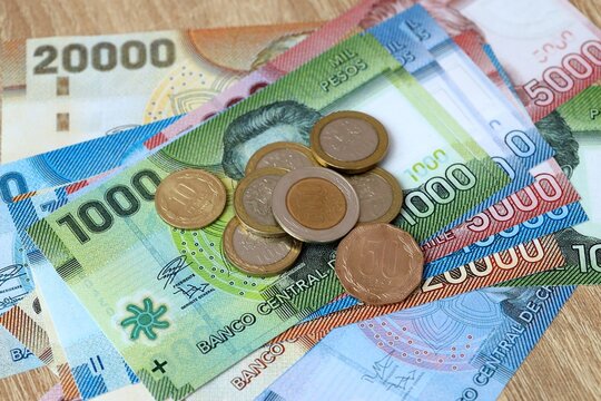 Chilean peso money bills and coins on table. Chile cash of CLP currency close up