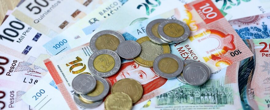 Mexican peso money bills and coins on table. Mexico cash of MXN currency close up