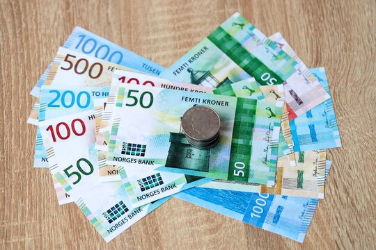 Norwegian krone money bills and coins on table. Norway cash of NOK currency close up