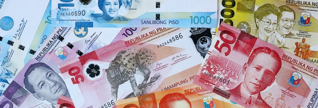 Philippine peso money banknotes bunch on table. Philippines bills of PHP currency close up