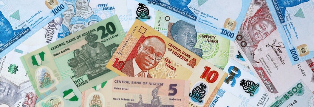 Nigerian naira money banknotes bunch on table. Nigeria bills of NGN currency close up