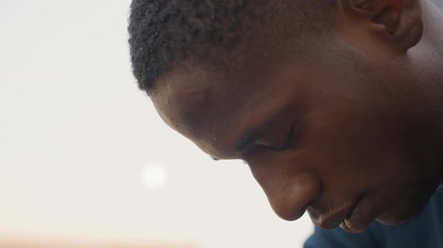 Closeup face with sawdust and focus, concentrated gaze with beads of sweat, careful inspection of wood surface during detailed carpentry work, blurred workshop background emphasizing determination