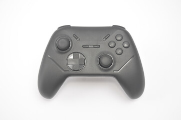 a black wireless gamepad controller isolated on a white background. Modern gaming hardware featuring dual analog sticks, directional pad, and action buttons for console or pc. © Setyotuhu