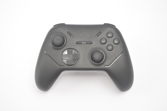 a black wireless gamepad controller isolated on a white background. Modern gaming hardware featuring dual analog sticks, directional pad, and action buttons for console or pc.