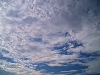 Obraz premium Amazing cloud views,: The clouds resemble altocumulus clouds, which often appear as small, stacked white or gray clumps.