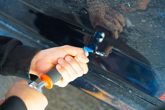 Removing dents on the car. PDR technology. Car body repair without painting.